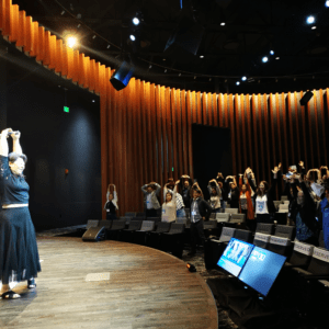 Jeni Chih guiding attendees in a stretch break